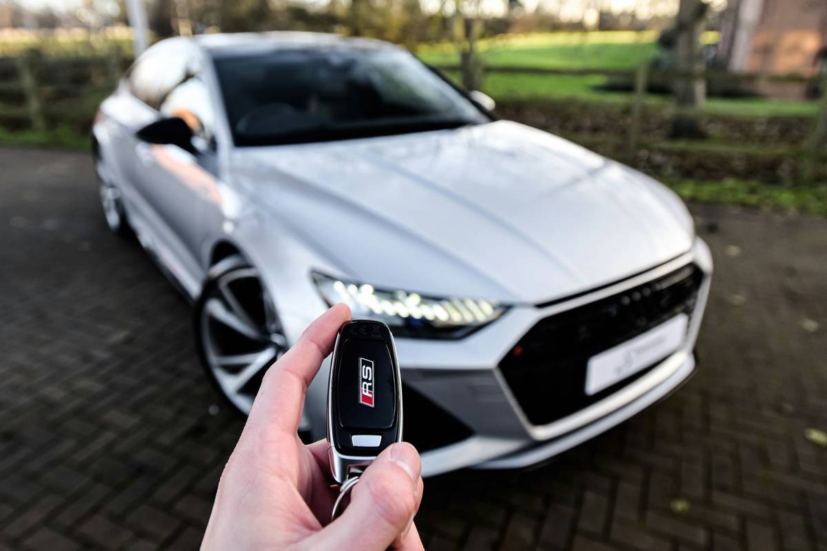 Rental car agent pointing to insurance checkbox on contract next to Insurance Activation Requirements